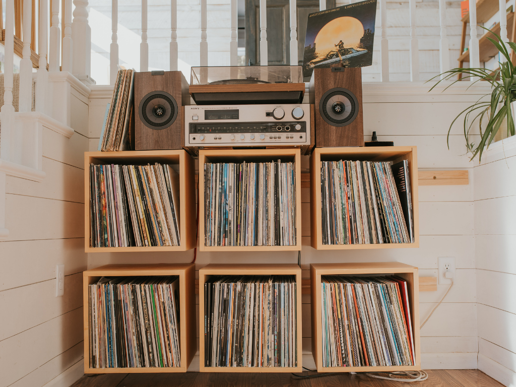 6 wall mounted record cube shelves in maple with a vintage Sony amplifier, a vintage DUAL turntable, and modern KEF speakers on top