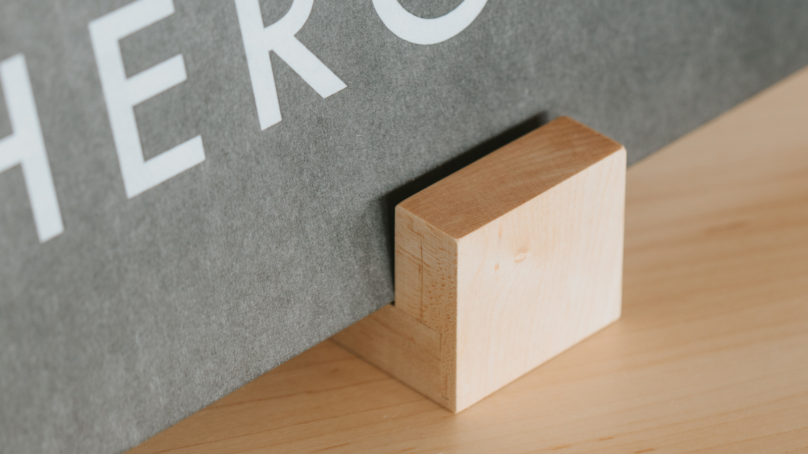 Tabletop record display stand for vinyl records in hard maple sitting on a maple table holding the record Pure Heroine by Lorde